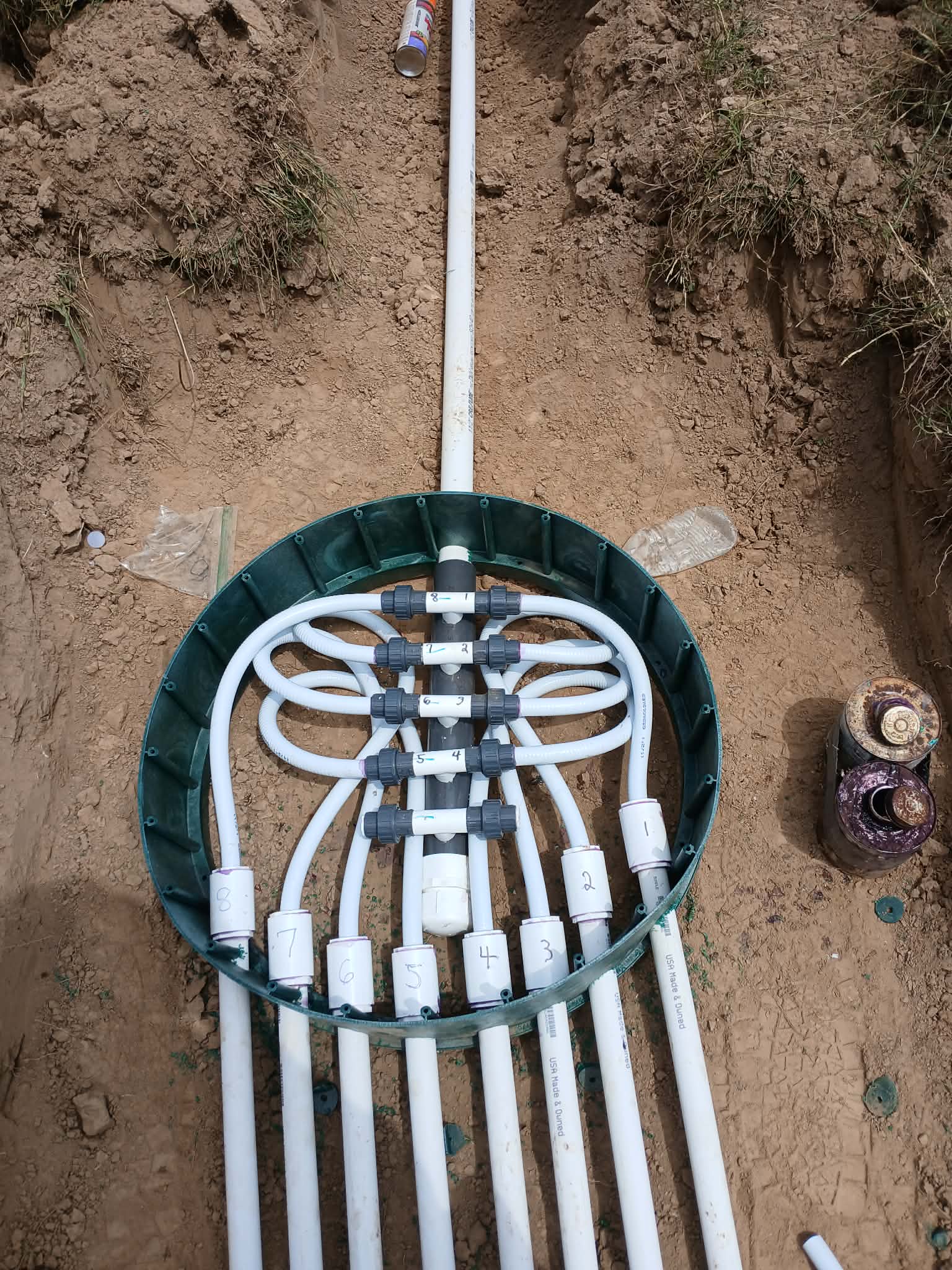 Septic distribution manifold with white pipes